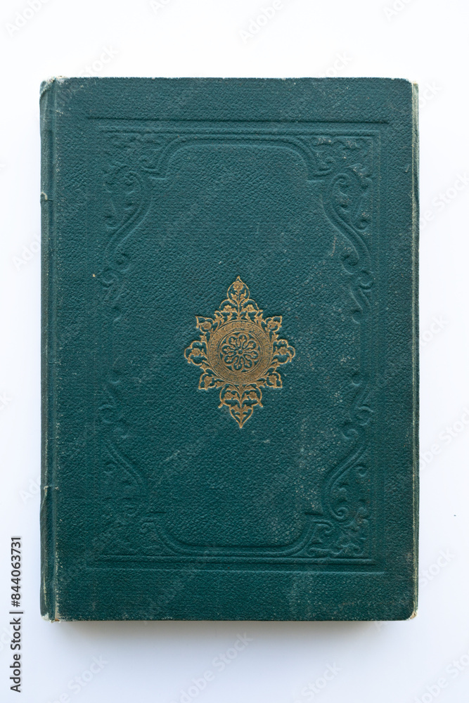 green coloured damaged cover of a very old book. yellowed natural paper texture. isolated on white background. clean close-up. green coloured damaged cover of a very old book. yellowed natural paper texture. isolated on white background. clean close-up.