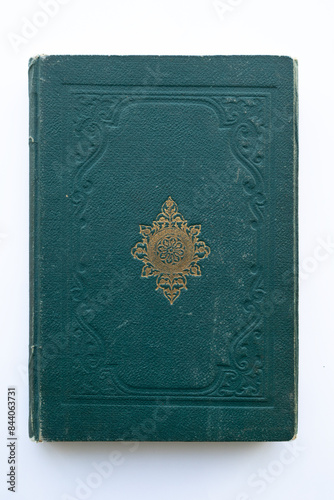 green coloured damaged cover of a very old book. yellowed natural paper texture. isolated on white background. clean close-up.