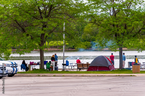 People Fishing And Picnicing At The Dock On Fox River Near De Pere, Wisconsin
