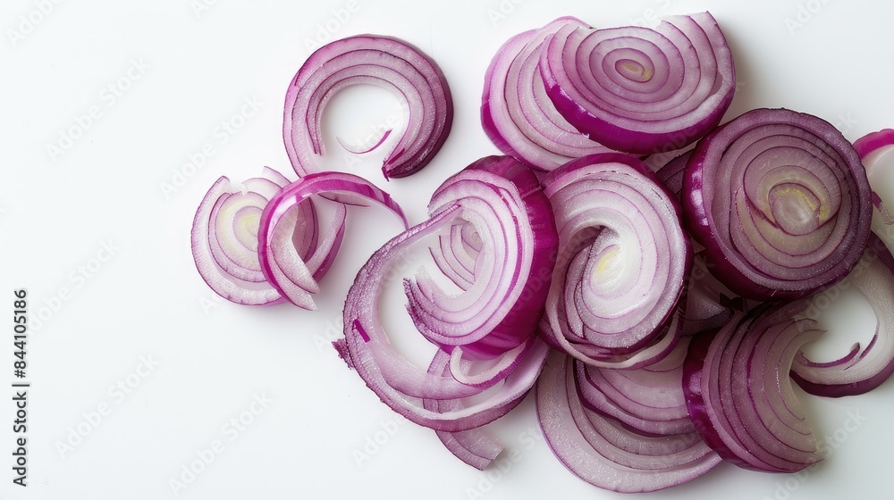 Sliced onion rings placed in a spiral shape on a clean, white background.