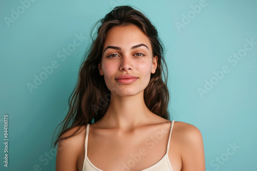 A close up portrait of a young woman with a subtle smile