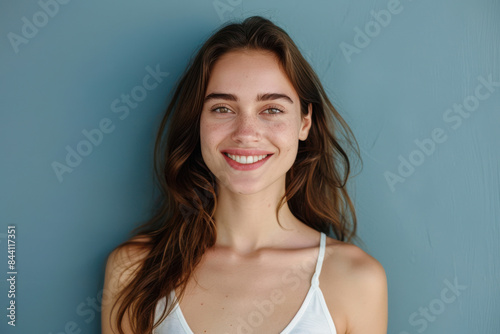 A close up portrait of a young woman with a subtle smile