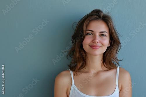 A close up portrait of a young woman with a subtle smile