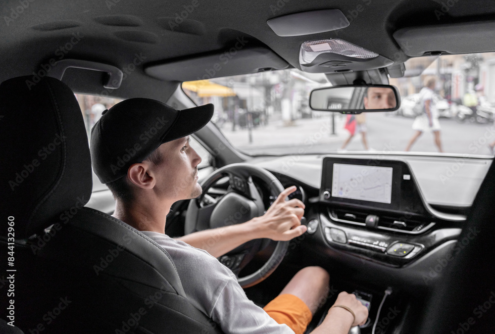 A young guy driving a car. A young guy driving a car.