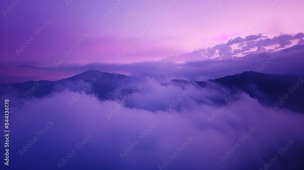 A purple sky with mountains in the background