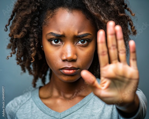 woman showing ok sign, Young African American woman making hand stop denial gesture, saying no violence, abuse, abortion, showing palm, expressing prohibition, refusal, fighting against discrimination photo