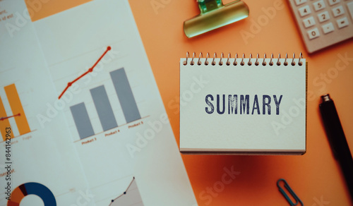 There is notebook with the word Summary. It is as an eye-catching image.