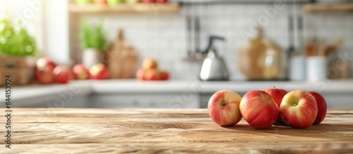 Blurred kitchen interior background with ripe apples © Lasvu