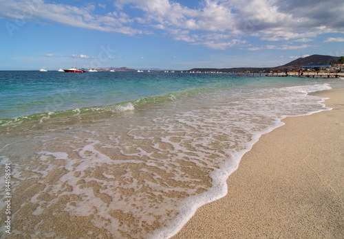 Summer vacations and adventure in La Paz Baja California Sur. Mexico. LOS BARRILES Beach with waves blue sea blue sky with clouds and mountains in the background. photo