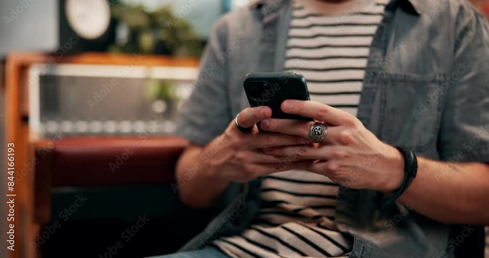 Hands, man and texting on smartphone in music studio for social media post or message as song producer. Musician, dj and artist with texting or networking for album ideas, recording and creativity