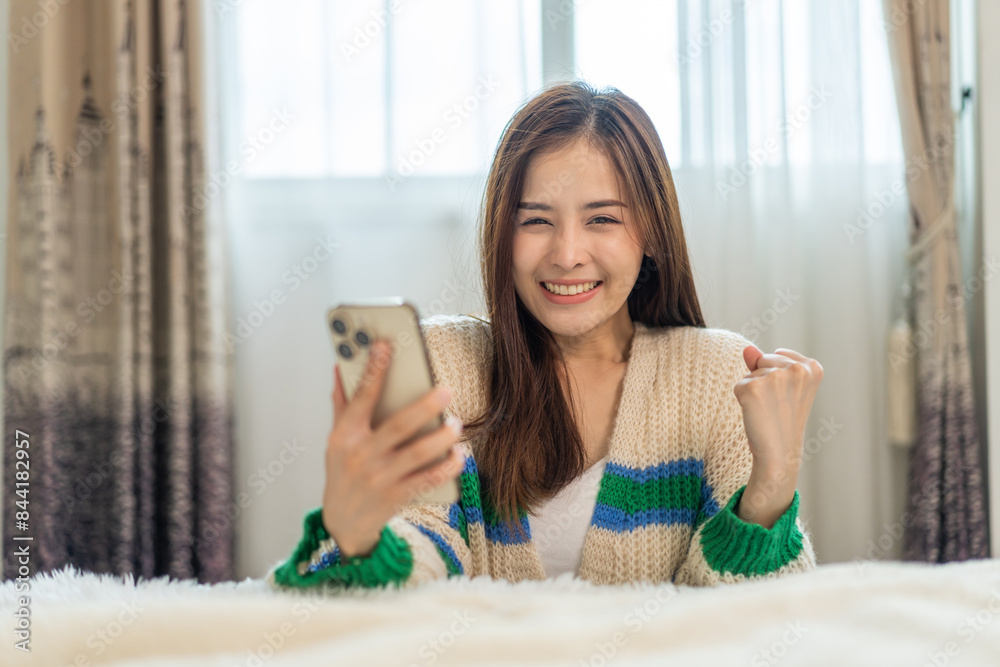 Portrait of smiling happy asian woman relax using digital smartphone.Young asian girl working or study,chatting social network and playing game online or social media,shopping online at home Portrait of smiling happy asian woman relax using digital smartphone.Young asian girl working or study,chatting social network and playing game online or social media,shopping online at home
