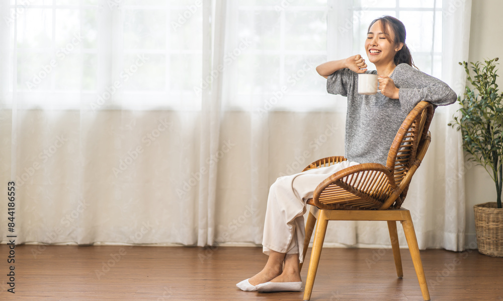 Portrait of smiling happy cheerful beauty pretty asian woman relaxing drinking and looking at cup of hot coffee or tea.Girl felling enjoy having breakfast in holiday morning vacation on bed at home Portrait of smiling happy cheerful beauty pretty asian woman relaxing drinking and looking at cup of hot coffee or tea.Girl felling enjoy having breakfast in holiday morning vacation on bed at home