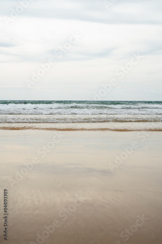 Beautiful Soft blue ocean wave on fine sandy beach photo