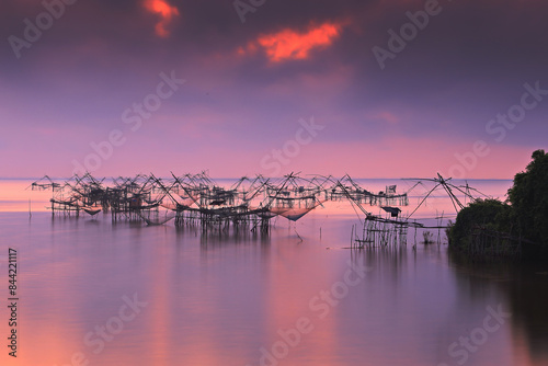 Sunrise and silhouette image of giant fishing net in the morning at Pakpra, Phatthalung, Thailand  photo