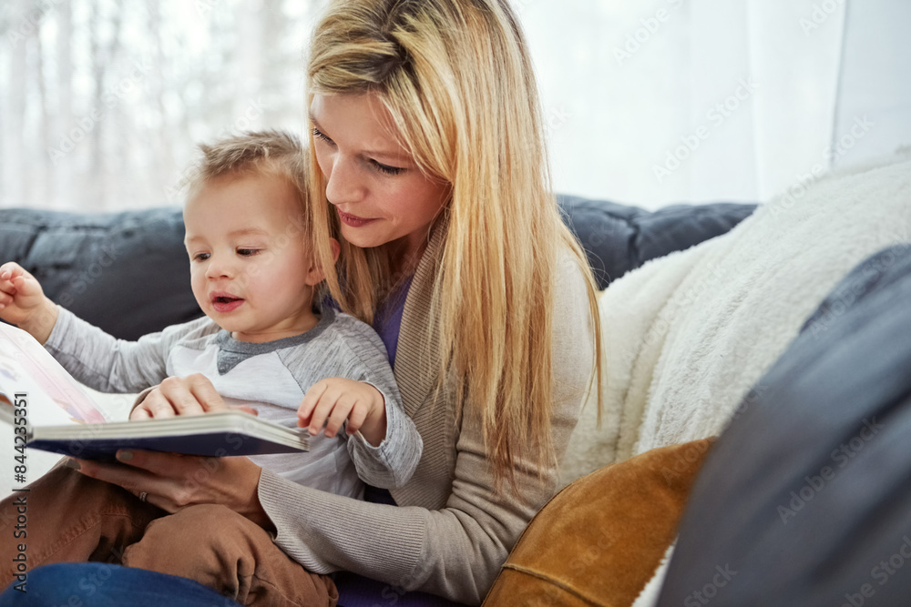 Reading, mother and boy on sofa with book, teaching and learning in family home and education. Knowledge, fantasy and storytelling, mama and son relax in living room together with love, care and calm Reading, mother and boy on sofa with book, teaching and learning in family home and education. Knowledge, fantasy and storytelling, mama and son relax in living room together with love, care and calm