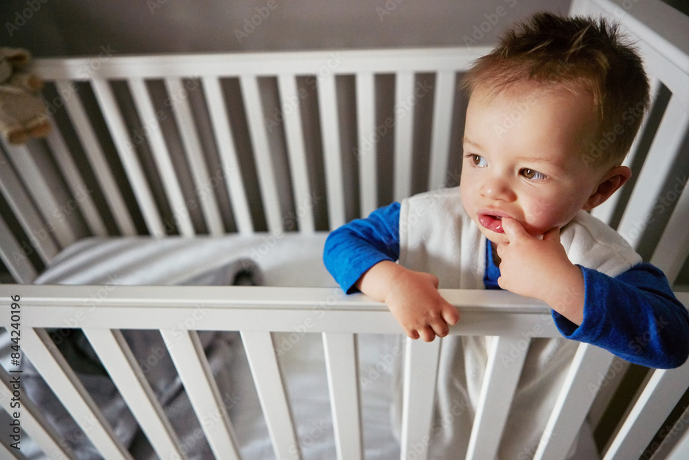 Wake up, curious and thinking kid in cute crib for child development, rest and childhood. Morning, care and innocent baby or young boy relaxing on a bed in his nursery or home bedroom cradle Wake up, curious and thinking kid in cute crib for child development, rest and childhood. Morning, care and innocent baby or young boy relaxing on a bed in his nursery or home bedroom cradle