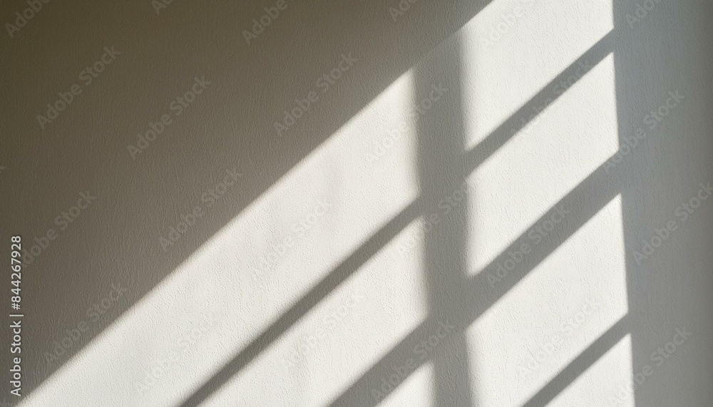 Blurry light shadow from window on white wall background Blurry light shadow from window on white wall background