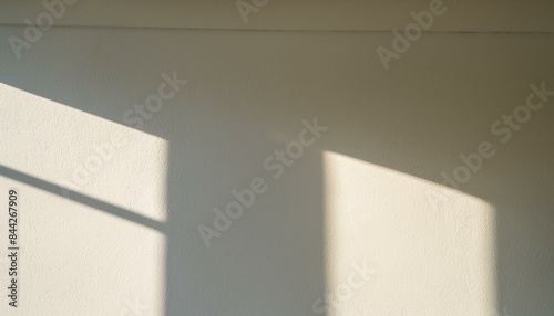 Blurry light shadow from window on white wall background