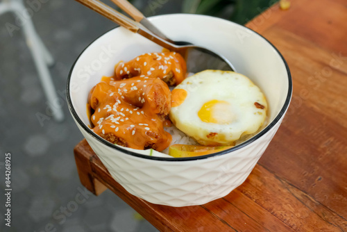 Rice Bowl Chicken Sauce Karage With Sunny Side Up Egg In The Table photo