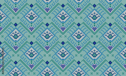 a detailed fabric pattern composed of pixelated designs and green background 