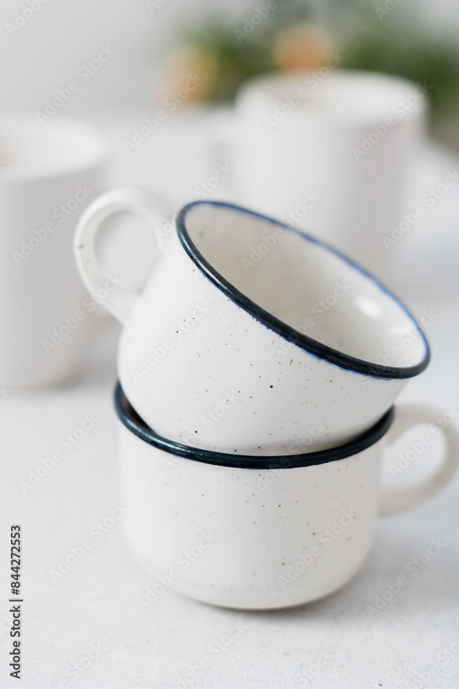 Close shot of white mugs pile in a white kitchen Close shot of white mugs pile in a white kitchen