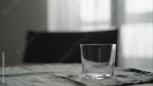 empty tumbler glass on linen cloth photo