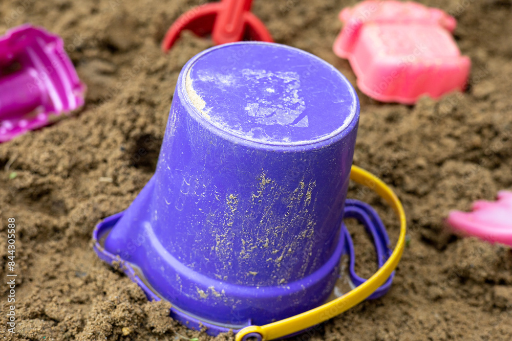 Beach and sand toys for digging and playing on the sand, buckets, moulds, spades. Summer fun, summer holiday background Beach and sand toys for digging and playing on the sand, buckets, moulds, spades. Summer fun, summer holiday background