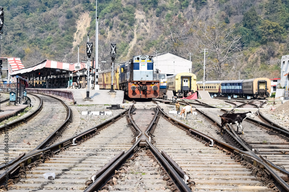 Obraz premium View of train Railway Tracks from the middle during daytime at Kathgodam railway station in India, Train railway track view, Indian Railway junction, Heavy industry