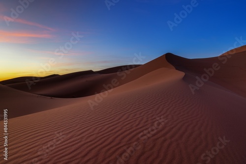 view of the sand dunes at Erg Chebbi in Morocco at sunset