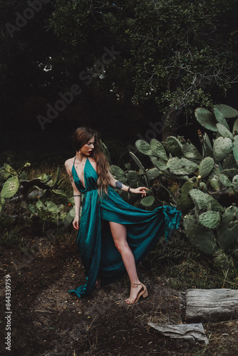 Indigenous woman posing in a garden of cactus and flowers 