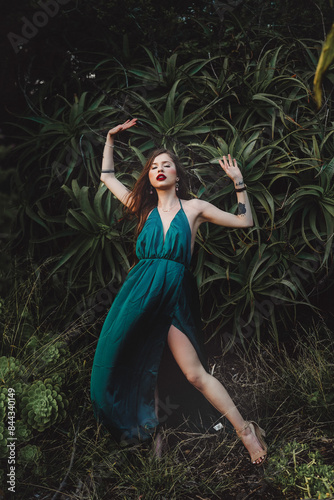 Indigenous woman posing in a garden of cactus and flowers 