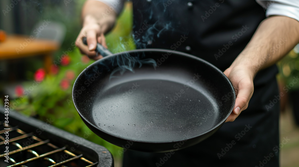 Closeup of chef holding empty pan with flame Cook prepares food on the stove in the kitchen of a restaurant or hotel. Closeup of chef holding empty pan with flame Cook prepares food on the stove in the kitchen of a restaurant or hotel.