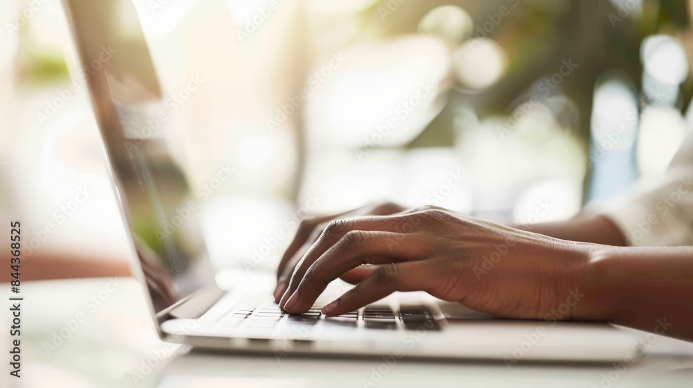 A close-up of a social workers hands typing rapidly on a laptop, researching resources A close-up of a social workers hands typing rapidly on a laptop, researching resources