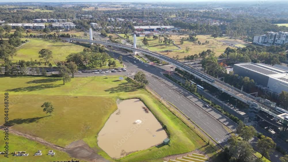 Aerial drone view of Rouse Hill Station on the metro northwest railway line, Greater Sydney, NSW Australia as a train departs the station crossing the railway bridge toward Tallawong in June 2024 Aerial drone view of Rouse Hill Station on the metro northwest railway line, Greater Sydney, NSW Australia as a train departs the station crossing the railway bridge toward Tallawong in June 2024