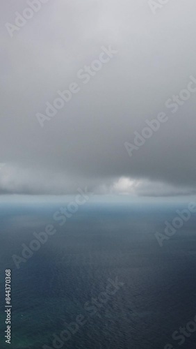 Wallpaper Mural Aerial vertical view. Dramatic moody and gloomy rain clouds over sea. Abstract aerial nature summer ocean sunset sea and sky. Horizon. Vacation, travel and holiday concept. Weather and climate change Torontodigital.ca