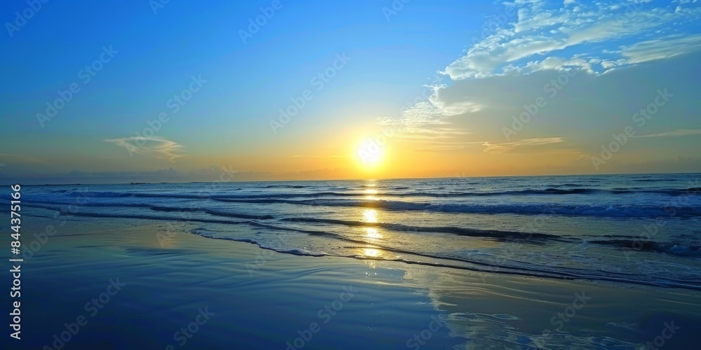 Fototapeta premium Sunset Over the Ocean at a Coastal Beach