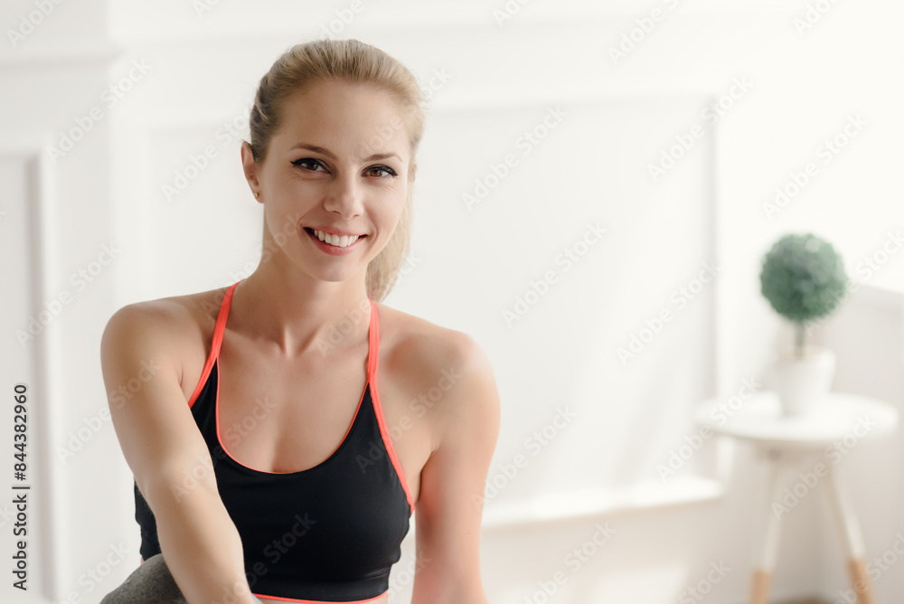 Cheerful preety woman in sportswear looking happy and relaxing after training Cheerful preety woman in sportswear looking happy and relaxing after training