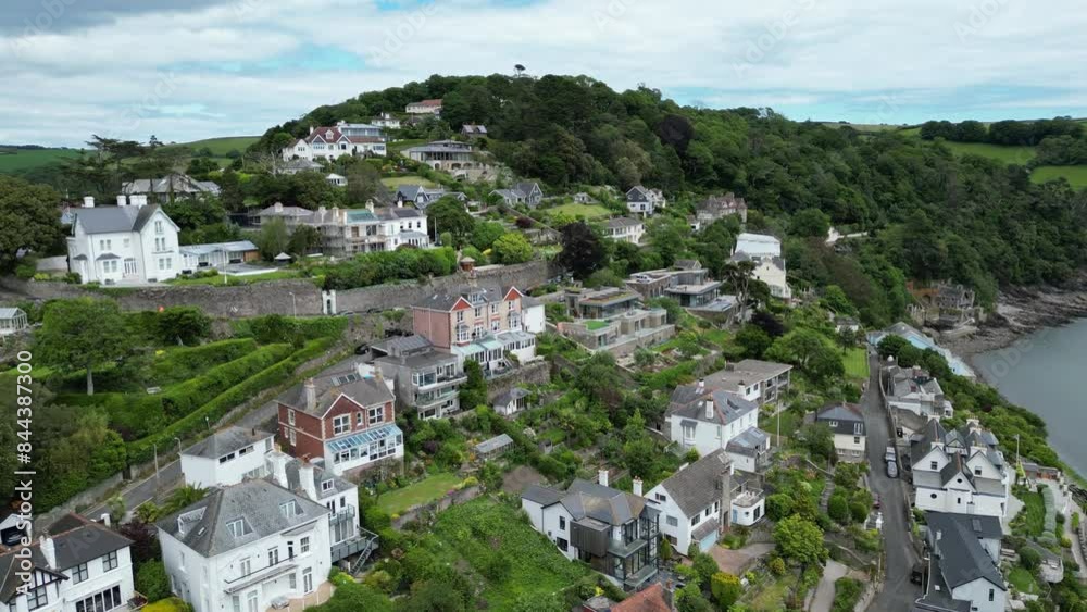Kingswear, South Devon, England: DRONE VIEWS: Boats on the River Dart and Kingswear houses. The River Dart is a popular English holiday destination and a magnet for sailing enthusiasts (Clip 3). Kingswear, South Devon, England: DRONE VIEWS: Boats on the River Dart and Kingswear houses. The River Dart is a popular English holiday destination and a magnet for sailing enthusiasts (Clip 3).