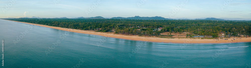 Panoraman aerial drone view of shoreline scenery with blue sea water at Pantai Jambu Bongkok, Marang, Terengganu, Malaysia Panoraman aerial drone view of shoreline scenery with blue sea water at Pantai Jambu Bongkok, Marang, Terengganu, Malaysia