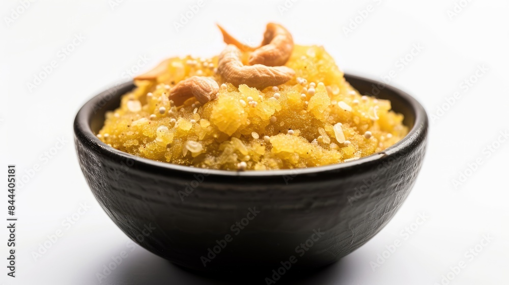 Suji halwa displayed in a black bowl against a white backdrop Suji halwa displayed in a black bowl against a white backdrop
