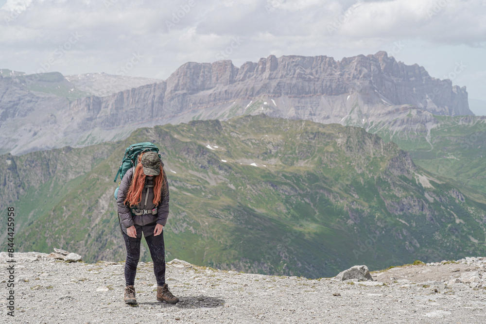 Fototapeta premium Woman hiking the tour du Mont Blanc in the beautiful mountains of France, Italy and Switzerland. Hiking the Alps. 