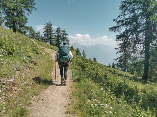 Woman hiking the tour du Mont Blanc in the beautiful mountains of France, Italy and Switzerland. Hiking the Alps. 