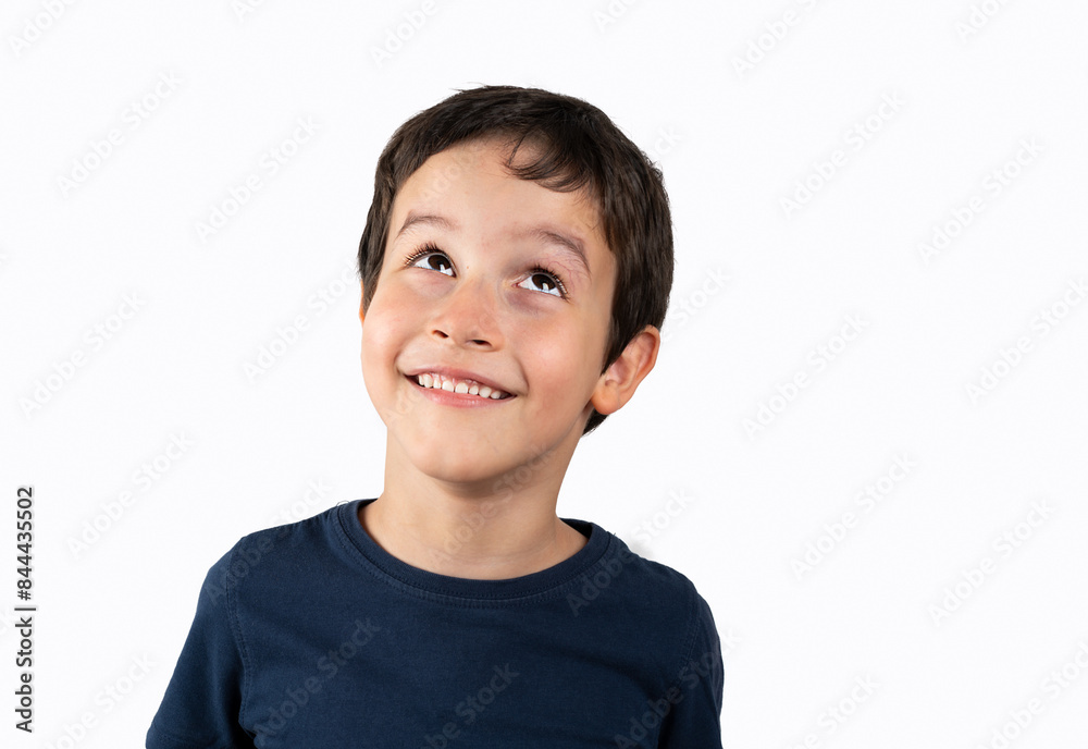 Portrait of a young boy looking up on white background Portrait of a young boy looking up on white background