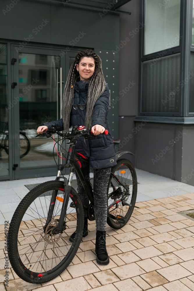 Bike rental concept, young caucasian woman riding a bike on the street Bike rental concept, young caucasian woman riding a bike on the street