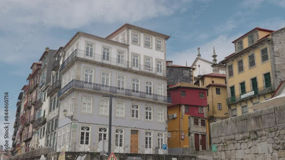 Porto, Portugal - A narrow street alleyways by the Douro River, Porto's old town with historic buildings and restaurants, the promenade and Ponte Luís I bridge. Porto, Portugal - A narrow street alleyways by the Douro River, Porto's old town with historic buildings and restaurants, the promenade and Ponte Luís I bridge.
