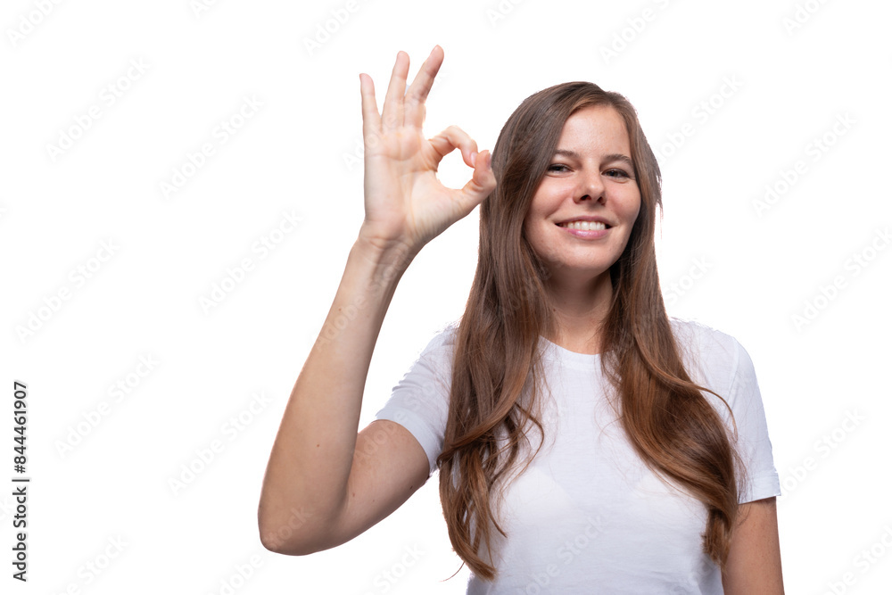 Young woman shows ok gesture and smiles sweetly Young woman shows ok gesture and smiles sweetly
