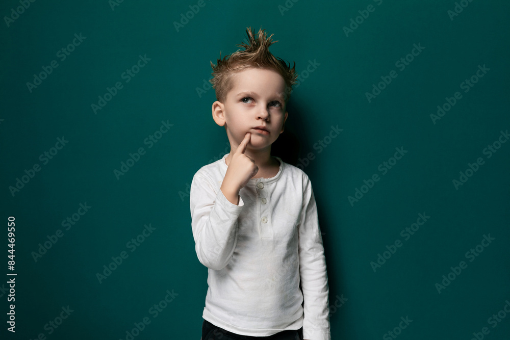 Little Boy Standing in Front of Green Wall Little Boy Standing in Front of Green Wall
