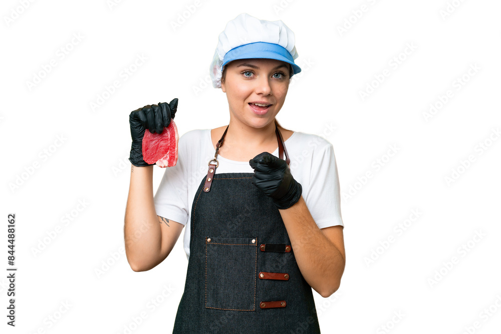 Butcher woman wearing an apron and serving fresh cut meat over isolated chroma key background surprised and pointing front Butcher woman wearing an apron and serving fresh cut meat over isolated chroma key background surprised and pointing front
