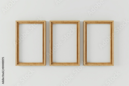 frames on the wall, A 3D rendering of a minimalistic interior featuring three wooden frames arranged symmetrically on a pristine white wall