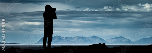 Fotograf im Gegenlicht als Silhouette beim Fotografieren von einem Landschaft...